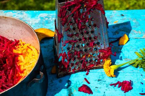 Old metal grate with grated beetroot  Stock Photos