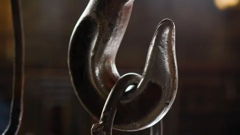 Old metal hook with hanging load in factory warehouse Stock Footage 243305674