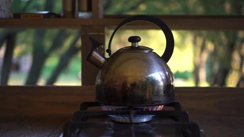 Old Metal Kettle is Warming up by a Fire Against background of a Glamping Tent Stock Footage 251791689