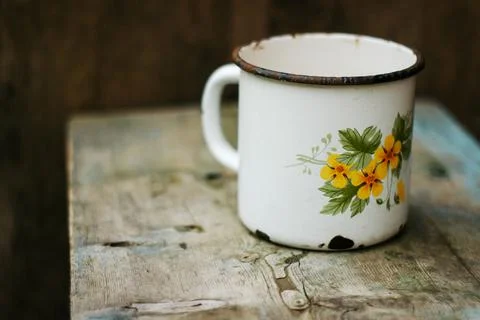 An old metal mug on an old table Stock Photos