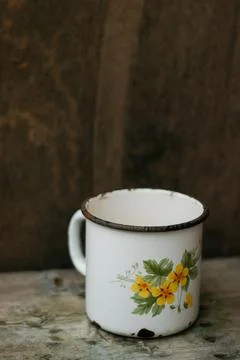 An old metal mug on an old table Stock Photos