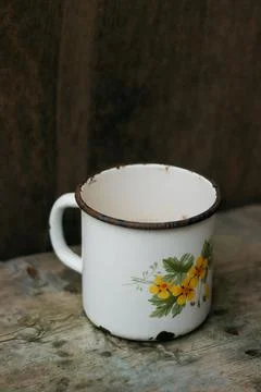 An old metal mug on an old table Stock Photos