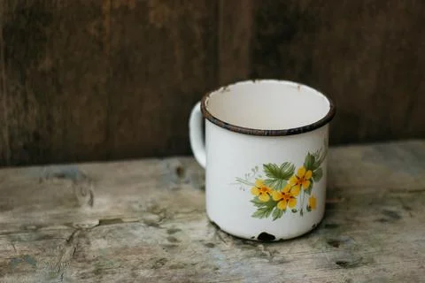 An old metal mug on an old table Stock Photos
