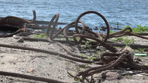 Old metal rusty ropes are tangled on river bank Stock Footage 63074518