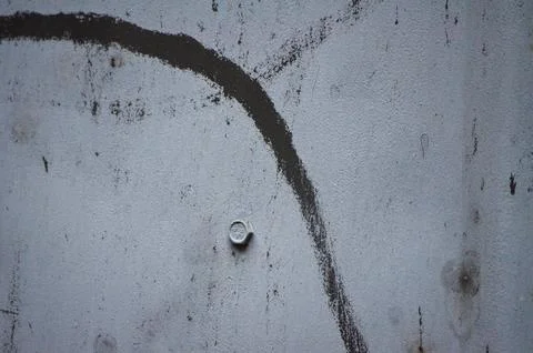 Old metal surface with a visible hexagonal bolt. Stock Photos