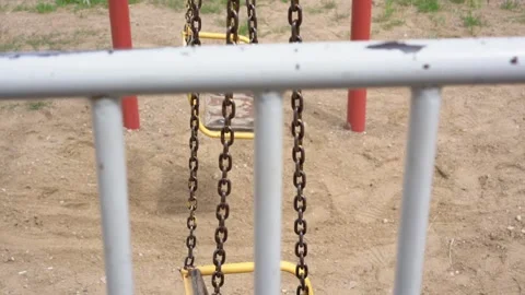 Old metal swing sways on rusty chains close side view Stock Footage 135516176