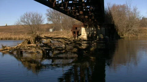 An old metal train bridge bridge crosses over a river (High Definition) Stock-Footage 65591