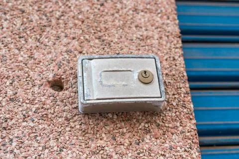 Old metal utility box with lock on concrete surface close up Stock Photos