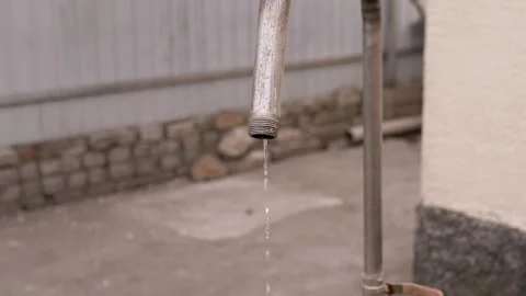 Old Metal Water Pipe Leaking Small Drops in Outdoor Backyard Garden Stock Footage 339068650