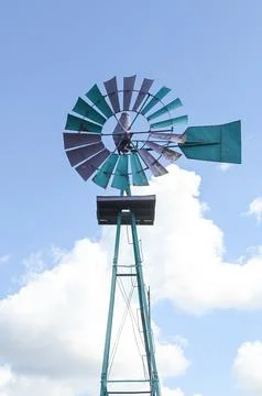 Old metal windmill under sky Stock Photos