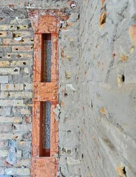  old metallic supporting column in brick wall Stock Photos