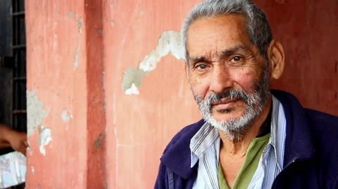 A old Mexican man poses for the camera down by the fishing docks Stock Footage 42403619