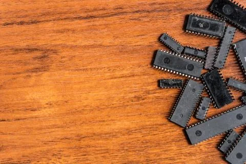 Old microchips on a wooden table lie with free space for text on the left. Mo Stock Photos