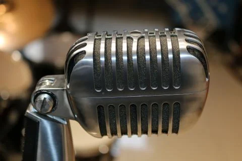 Old microphone on blurred background Stock Photos