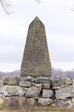 An old milestone in granit stone  with text 1781 Stock Photos