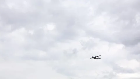 Old military airplane Lockheed C130 Hercules flies low under heavy storm clouds  Stock Footage 311662242