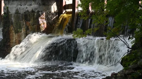 An old mill dam on a summer river with falling and foaming water Stock Footage 234608304