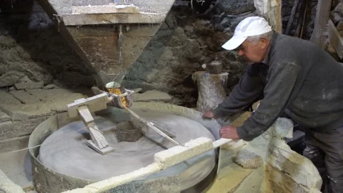 Old mill for grinding grain up close. The miller grinds grain Stock Footage 140141057
