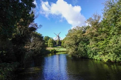 An old mill by a scenic river surrounded by nature Stock Photos