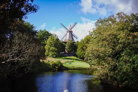 An old mill by a scenic river surrounded by nature Foto stock