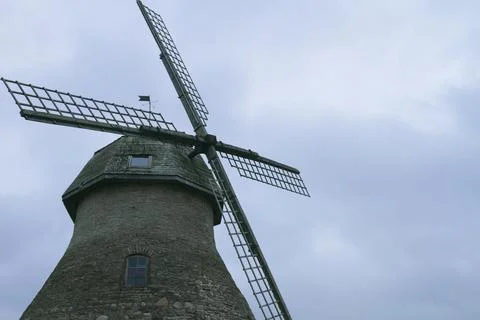 Old mill on the sky background. Stock Photos