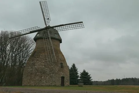 Old mill on the sky background. Stock Photos