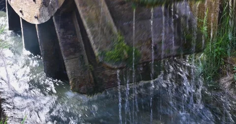 The old mill turns on a small stream Stock Footage 149014801