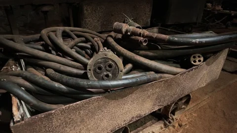 Old Mine Cart Filled with Coiled Industrial Hoses, Slow Pan Stock Footage 345644976