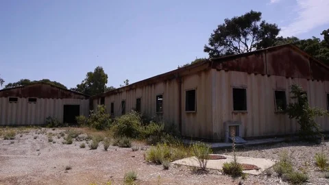 Old mine rust sheet metal building sardinia static Stock Footage 94721027