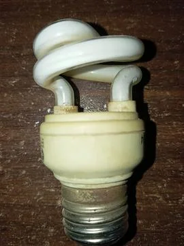 Old mini dusty bulb upper pose on the table Stock Photos