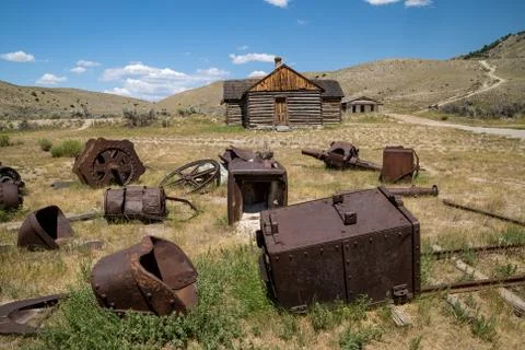Old mining equipment, abandoned, rusting in the grass in Bannack Ghost Town i Stock Photos
