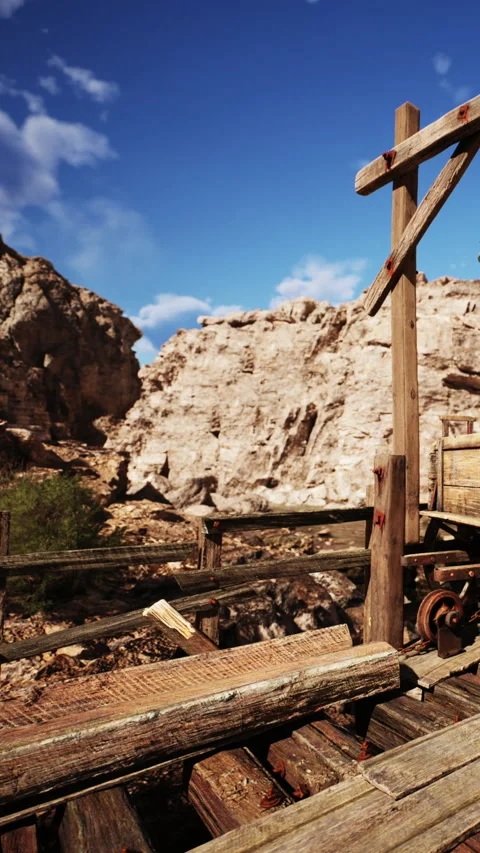 Old mining equipment stands under a blue sky in a rocky area Stock Footage 339777959
