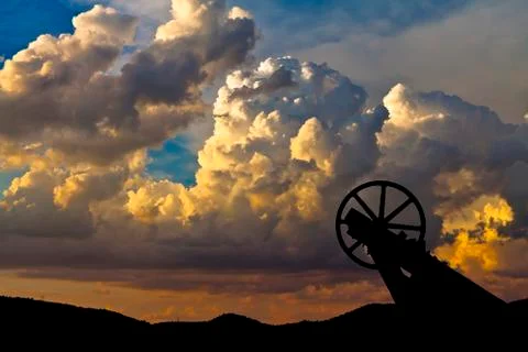 Old mining hoist with dramatic cloud background Stock Photos