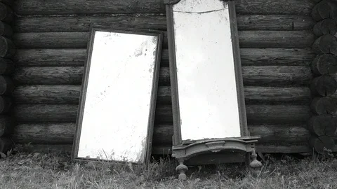 Old mirrors by the log wall, black and white Stock Footage 117112529