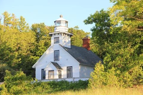 Old Mission Lighthouse Surrounded by Trees at Golden Hour Stockfoto's