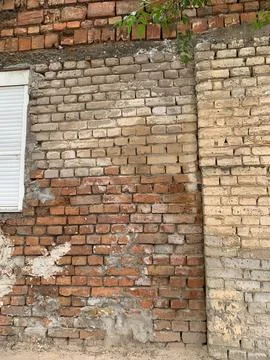 Old Mixed Brick Wall with Weathered Texture Stock Photos