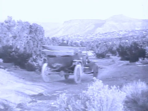 Old Model T type car drives in desert near Santa Fe Stock-Footage 139947538