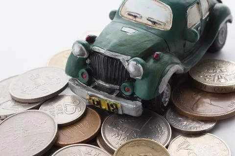 Old model toy car with stack of coins Stock Photos