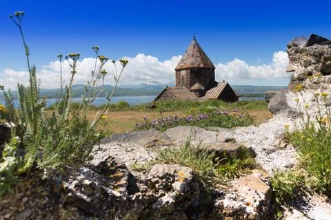 The old monastery on the hill in mountains. Monastery near the lake in Armenia Stock Photos