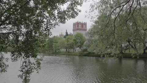 Old Monastery reflecting in the water in summer park Stock Footage