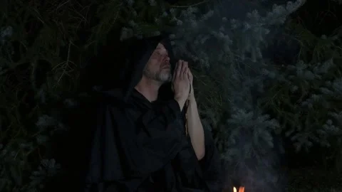 An old monk praying by the fire, immersed in reflection. Stock Footage 303783481