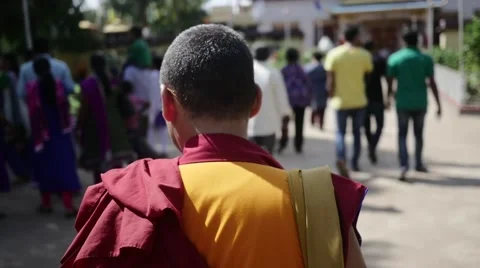 Old monk walking to Bylakuppe monastery in slow motion Stock Footage 60206070