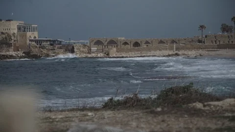 Old monument in slow motion as waves crash onto the beach of Caesarea Video stock 86070892