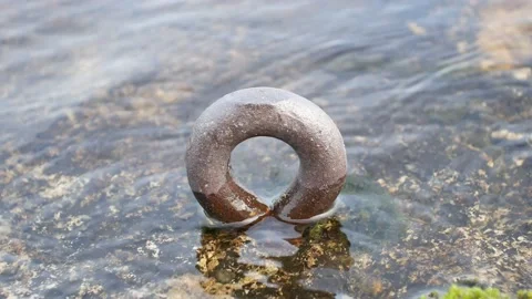 Old mooring ring on shore Stock-Footage 156783655