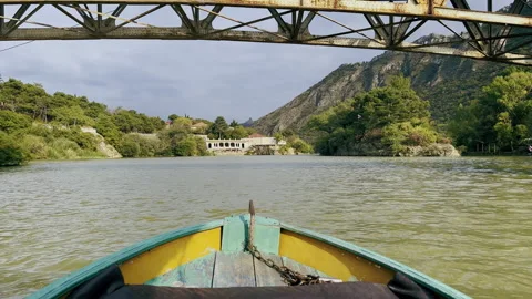 Old motor boat going under Iron Princess Jorjoliani Bridge. Mtskheta, Georgia Stock Footage 264267624
