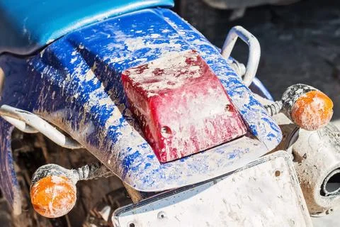 Old motorcycle with dirty tail light box Stock Photos