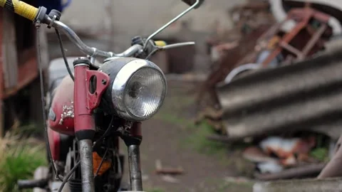 Old motorcycle in the dust. Red retro moto. Defective motorcycle, needs repair Stock Footage 269701239
