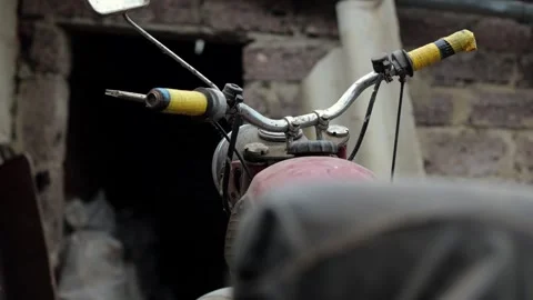 Old motorcycle in the dust. Red retro moto. Defective motorcycle, needs repair Stock Footage 269701283