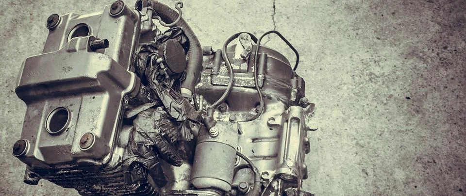 Old motorcycle engine isolate in workshop closeup Stock Photos