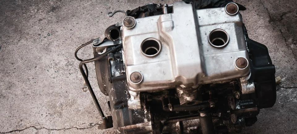 Old motorcycle engine isolate in workshop closeup Stock Photos